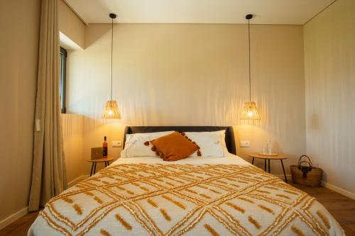 a bedroom with a large bed with two side tables at Casa de Algar - Enoturismo in Castelo de Paiva