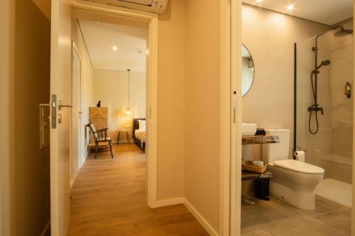 a bathroom with a toilet and a sink at Casa de Algar - Enoturismo in Castelo de Paiva