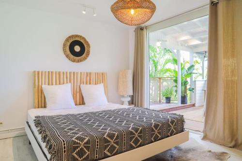 a bedroom with a bed and a large window at Kirsty's Place in Saint Barthelemy