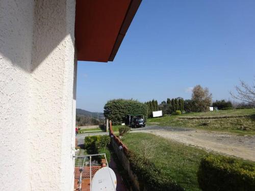 a view of a house with a yard and a road at Casa in collina, vista mare. in Nibbiaia