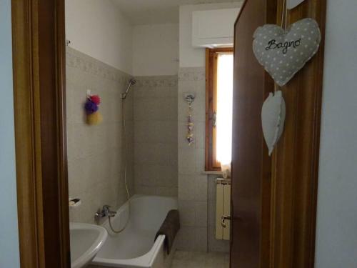 a bathroom with a tub and a sink and a bath tub at Casa in collina, vista mare. in Nibbiaia
