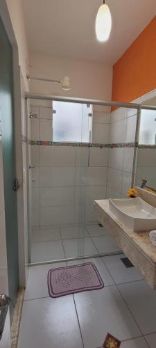 a bathroom with a shower and a sink at Pousada Paraty Graziela in Paraty