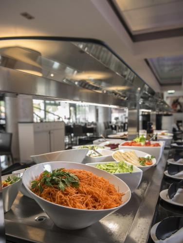 a restaurant kitchen with bowls of food on a counter at Vila Gale Evora in Évora