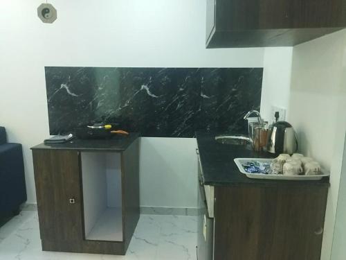 a kitchen with a black counter top and a sink at Seapoint(Seascape) in Dapoli