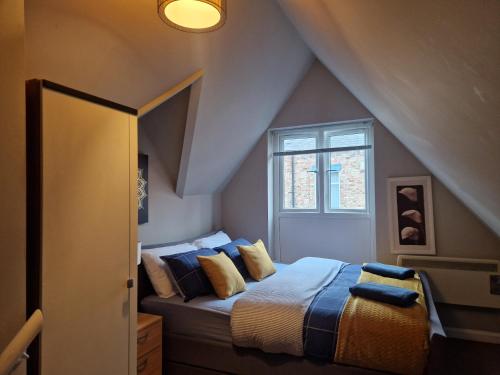 a bedroom with a bed in a attic at Primos Suite - Stylish 1 Bedroom in Wallsend in Old Walker