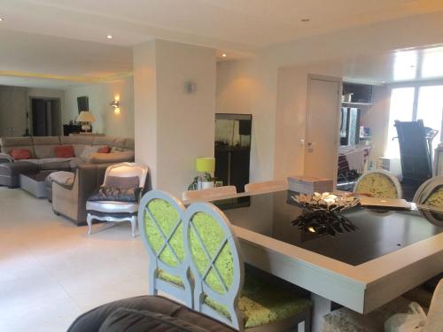 un salon avec une table et des chaises dans l'établissement Un air de campagne à Paris, à Saint-Maurice