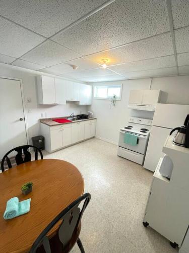 a kitchen with a wooden table and a kitchen with a stove at Appartment in Iroquois falls in Iroquois Falls