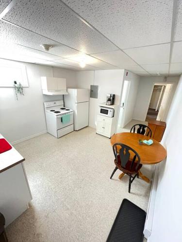 an overhead view of a kitchen with a table and chairs at Appartment in Iroquois falls in Iroquois Falls