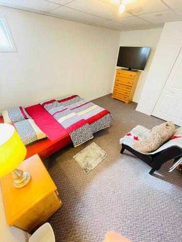 um quarto com uma cama, uma cómoda e uma televisão em Appartment in Iroquois falls em Iroquois Falls
