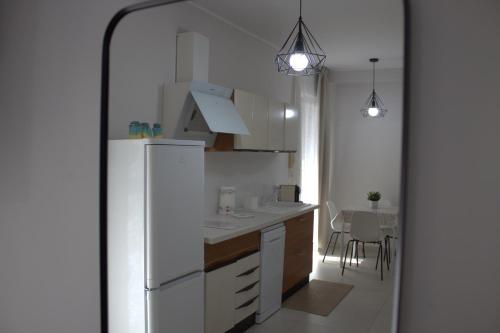 a kitchen with a white refrigerator and a table at B&B Sibi in Chieti