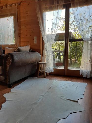 a living room with a couch and a large window at Landhaus Manjul in Rammersdorf