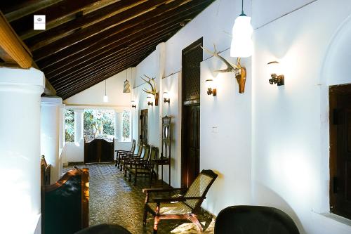 a hallway with chairs and a table in a building at Walawwa Matale in Matale