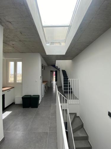 a hallway with a skylight in a building with stairs at Minimal & Arty Townhouse in Hamrun