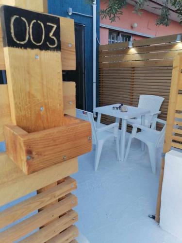 a patio with a table and a table and chairs at Angel's Houses in Skala Kallonis