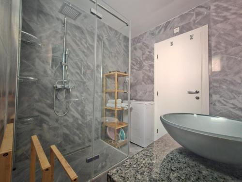 a bathroom with a glass shower and a tub at Vila Regina Apartment Rex with Swimming Pool in Jezera
