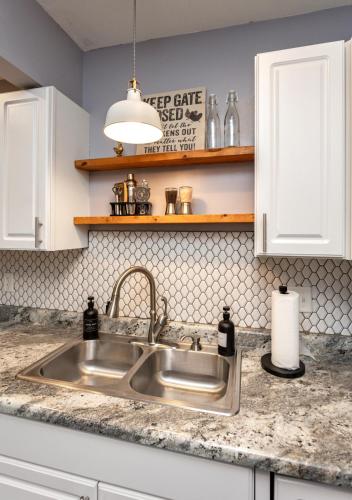 a kitchen with a sink and a counter top at Near Drake/Downtown packed w/Amenities - Hot Tub - Movie Theater in Des Moines