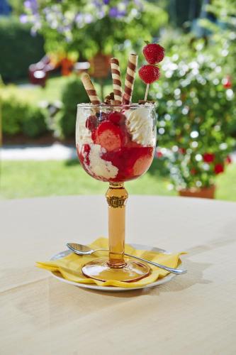 a dessert in a glass on a plate on a table at Gourmet-Hotel Grünwald in Leogang