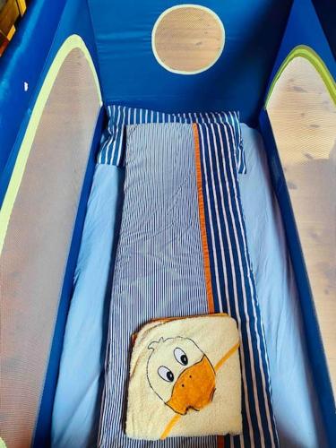 a seat in a toy truck with a face painted on it at Birkenhof, Haus Schwänli in Herisau