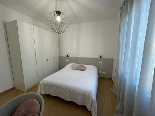 a small bedroom with a bed and a chandelier at Casa CarLa in Ancona