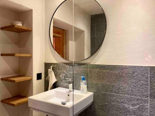a bathroom with a sink and a mirror at LA CÀ NOVA. South Switzerland cozy gate away. in Osco