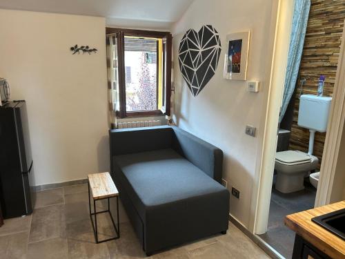 uma sala de estar com um sofá e um WC em Rose' s House Fiera Milano em Senago