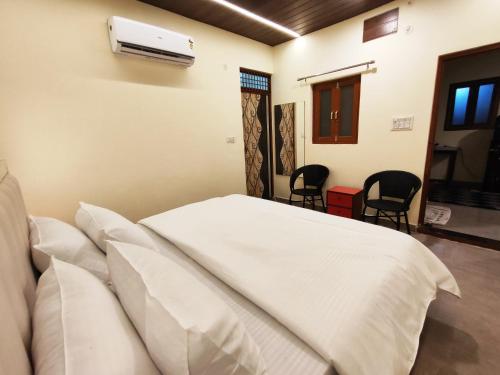 a bedroom with a bed and a air conditioner at Sunrise Homestay Agra Near Taj Mahal in Agra