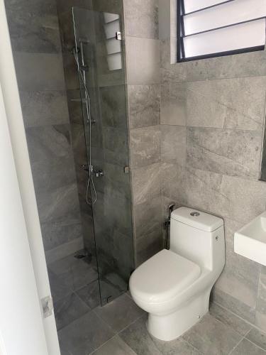 a bathroom with a toilet and a shower at Equine Residence Getaway in Seri Kembangan