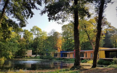 a house in the woods with a pond at Domaine de la Résidence - Hôtel, Spa & Restaurant in Moulins-lès-Metz