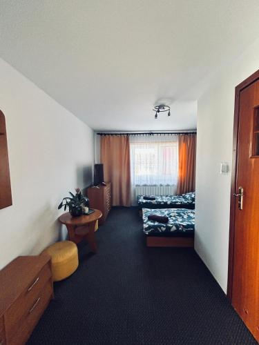 a hotel room with a bed and a window at Zajazd Kasieńka pokój 2 in Orzysz