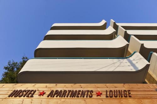 a building with two beds in front of it at STAY Rhodes HoStel & Bar in Rhodes Town