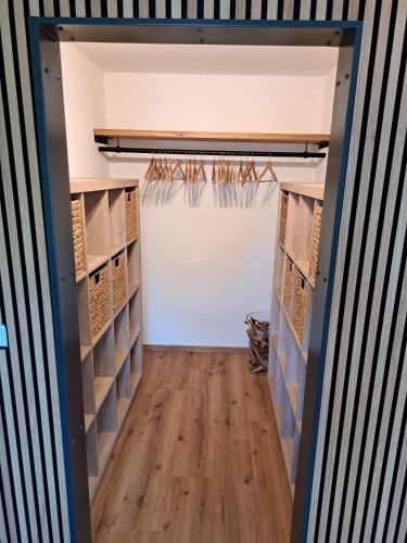 a room with a white garage door and wooden floors at Design Apartment an der Via Claudia in Oberigling