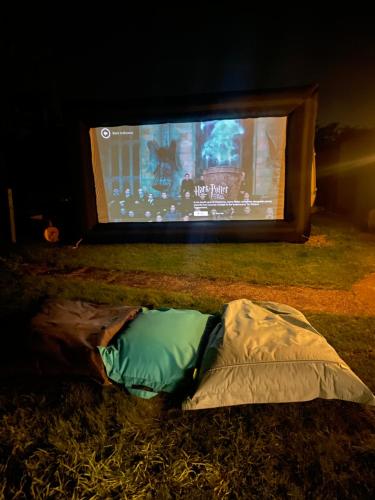 a tent in front of a tv at night at Country Bumpkins Luxury Glamping in Wellingore