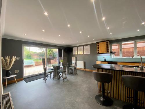 a kitchen and dining room with a table and chairs at Countryside family home in Longwell Green