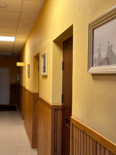 an empty hallway of a building with a door at Viesnīcas Jolanta apartamenti in Kolberģi