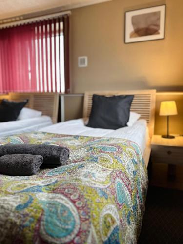 a hotel room with two beds in a room at Viesnīcas Jolanta apartamenti in Kolberģi