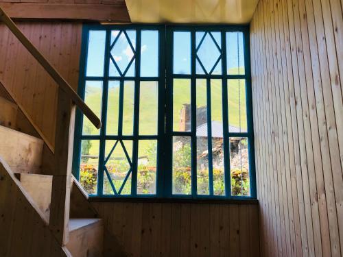a staircase with a window in a room with a stair case at Ela in Ushguli