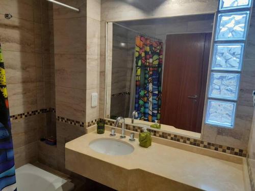 a bathroom with a sink and a stained glass window at Hermoso departamento 3 amb. en el centro de Olivos in Olivos