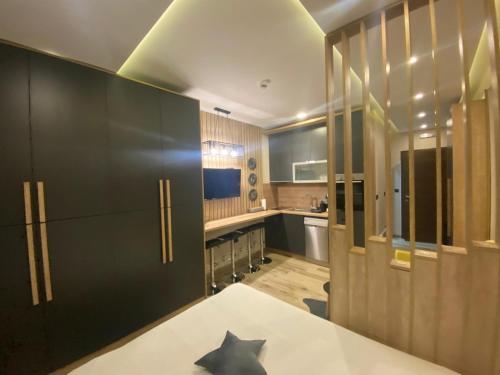 a kitchen with black cabinets and a counter top at Lana Lux Milmari Resort in Kopaonik
