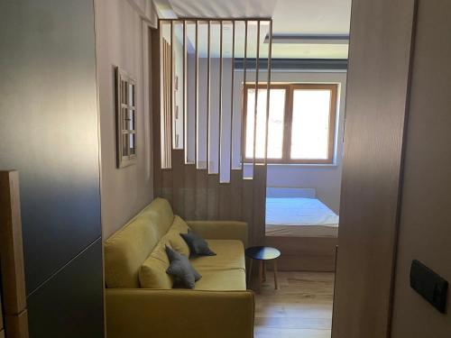 a living room with a couch and a bedroom at Lana Lux Milmari Resort in Kopaonik