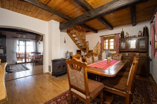 a kitchen with a wooden table and a dining room at Kuća za odmor Poljanica Okićka in Jastrebarsko