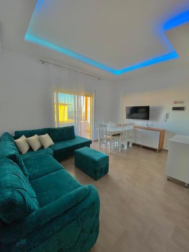 uma sala de estar com um sofá verde e uma mesa em Luxury Durres Apartament Sea View em Durrës