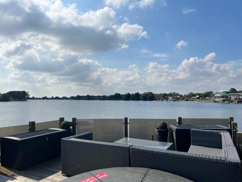 a deck with a view of a body of water at Lake View with Private Hot Tub at Tattershall Lakes in Tattershall