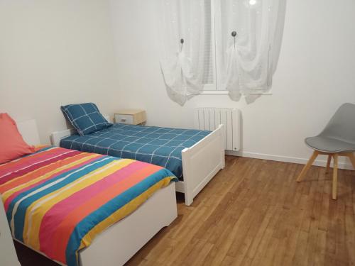 Llit o llits en una habitació de Maison KER MORIN
