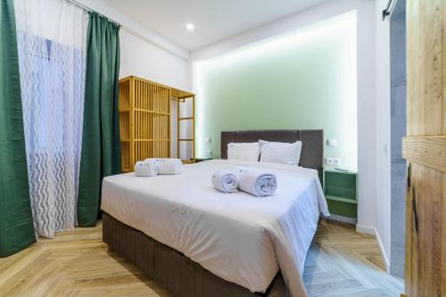 a bedroom with a large bed with towels on it at Atlantic Bliss in Albufeira