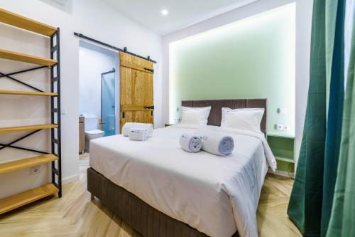a bedroom with a large bed with towels on it at Atlantic Bliss in Albufeira