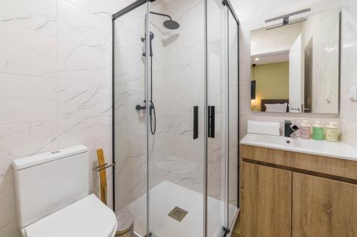 a bathroom with a shower and a toilet and a sink at Atlantic Bliss in Albufeira