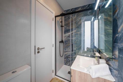a bathroom with a sink and a mirror at Atlantic Bliss in Albufeira
