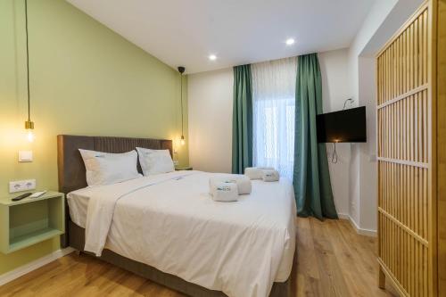 a bedroom with a bed with two towels on it at Atlantic Bliss in Albufeira