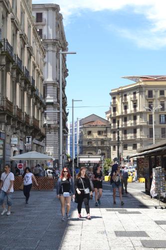a group of people walking down a city street at Hotel Cineholiday in Naples
