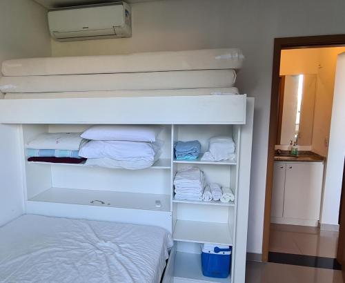 a bedroom with a bunk bed and a white bunk bed at Apto completo praia Caioba in Matinhos